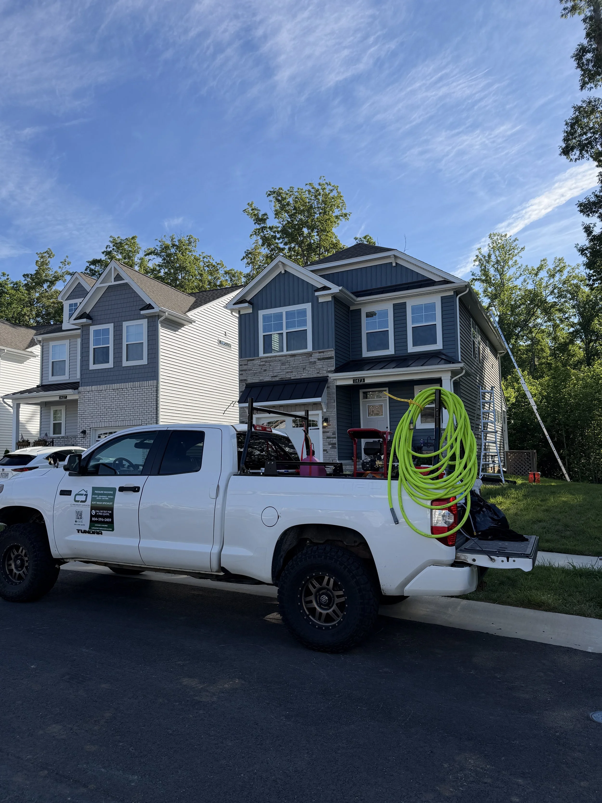 CJ Property Services truck with pressure washing and soft wash equipment at a job site in Chesterfield County, VA