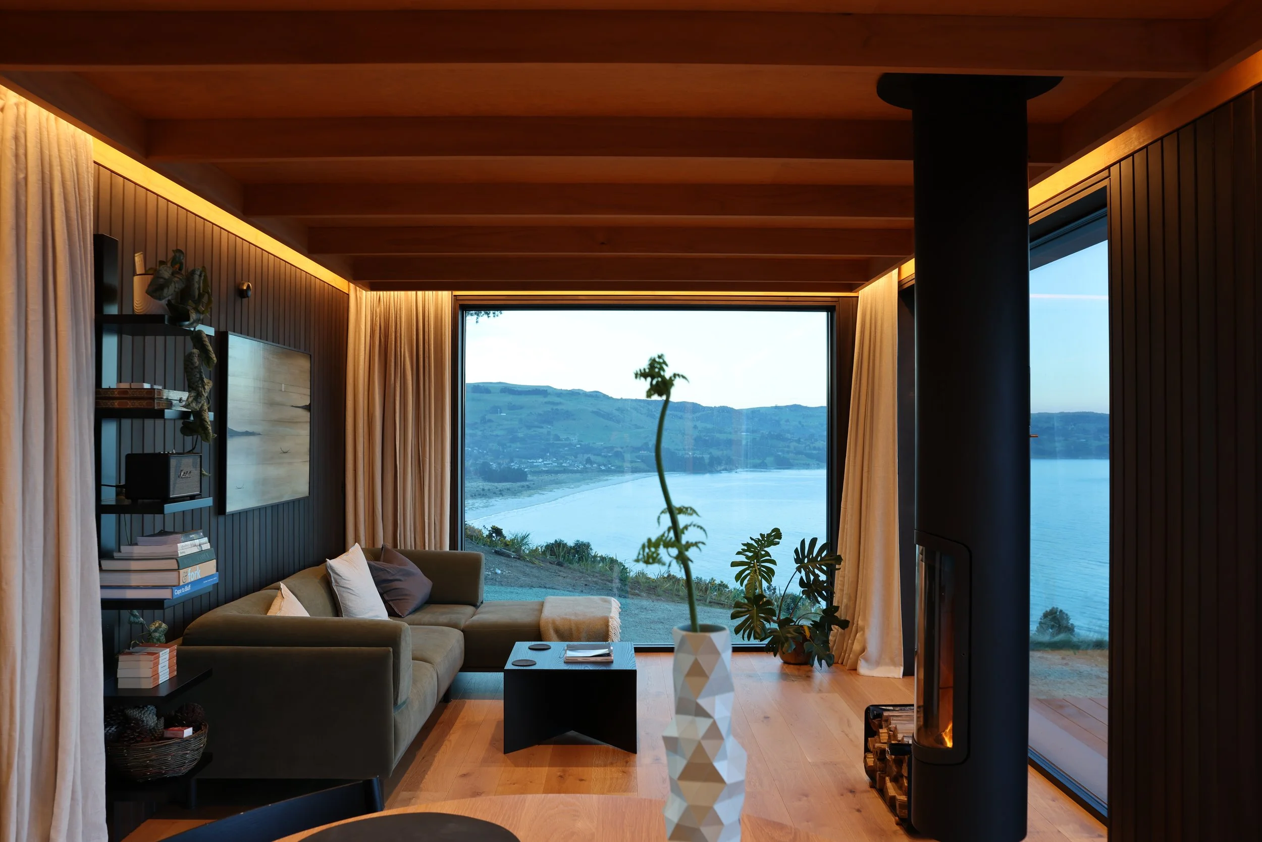Living room with large windows overlooking the ocean.