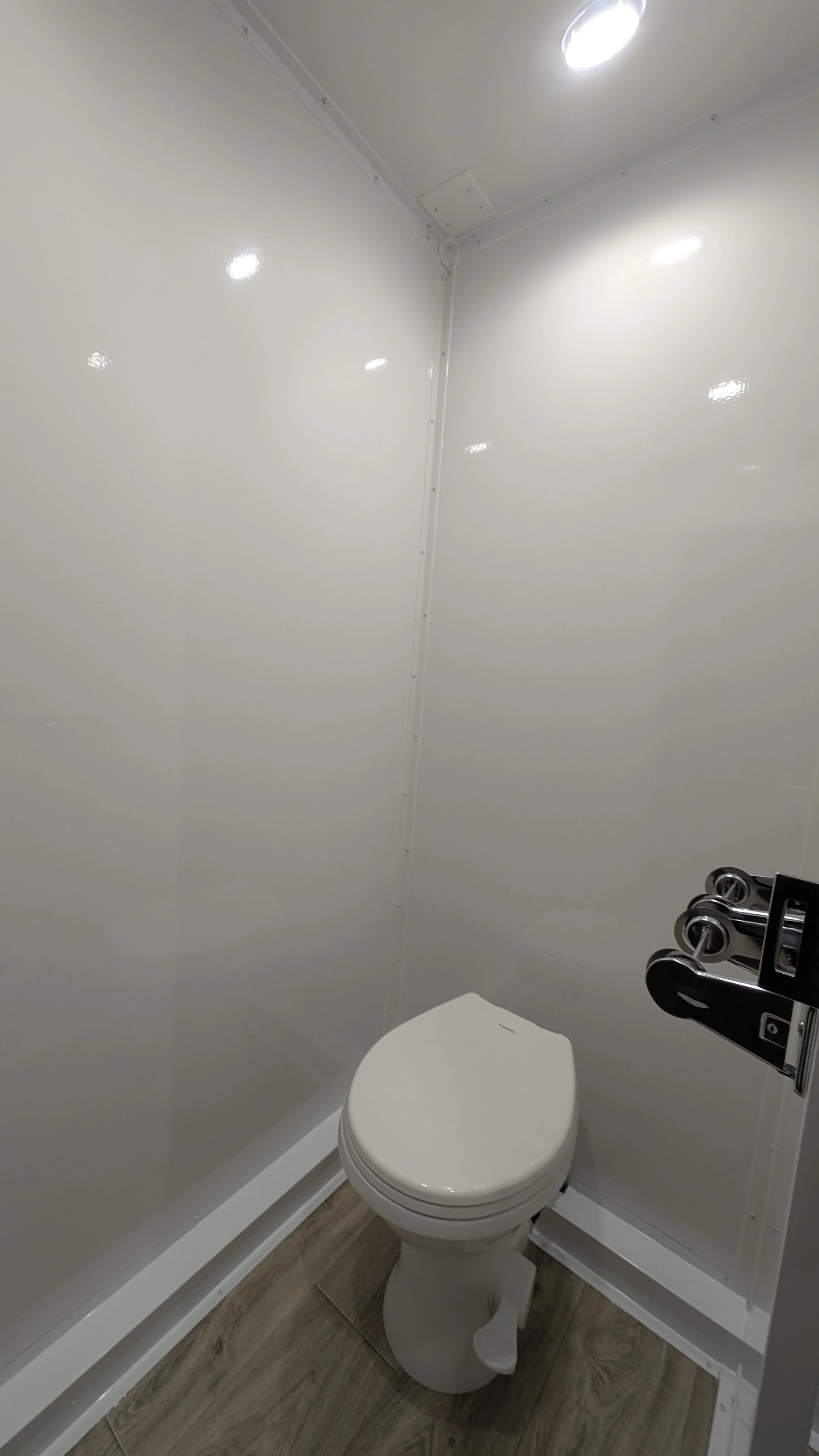 comfortable toilet with running water and toilet paper holder