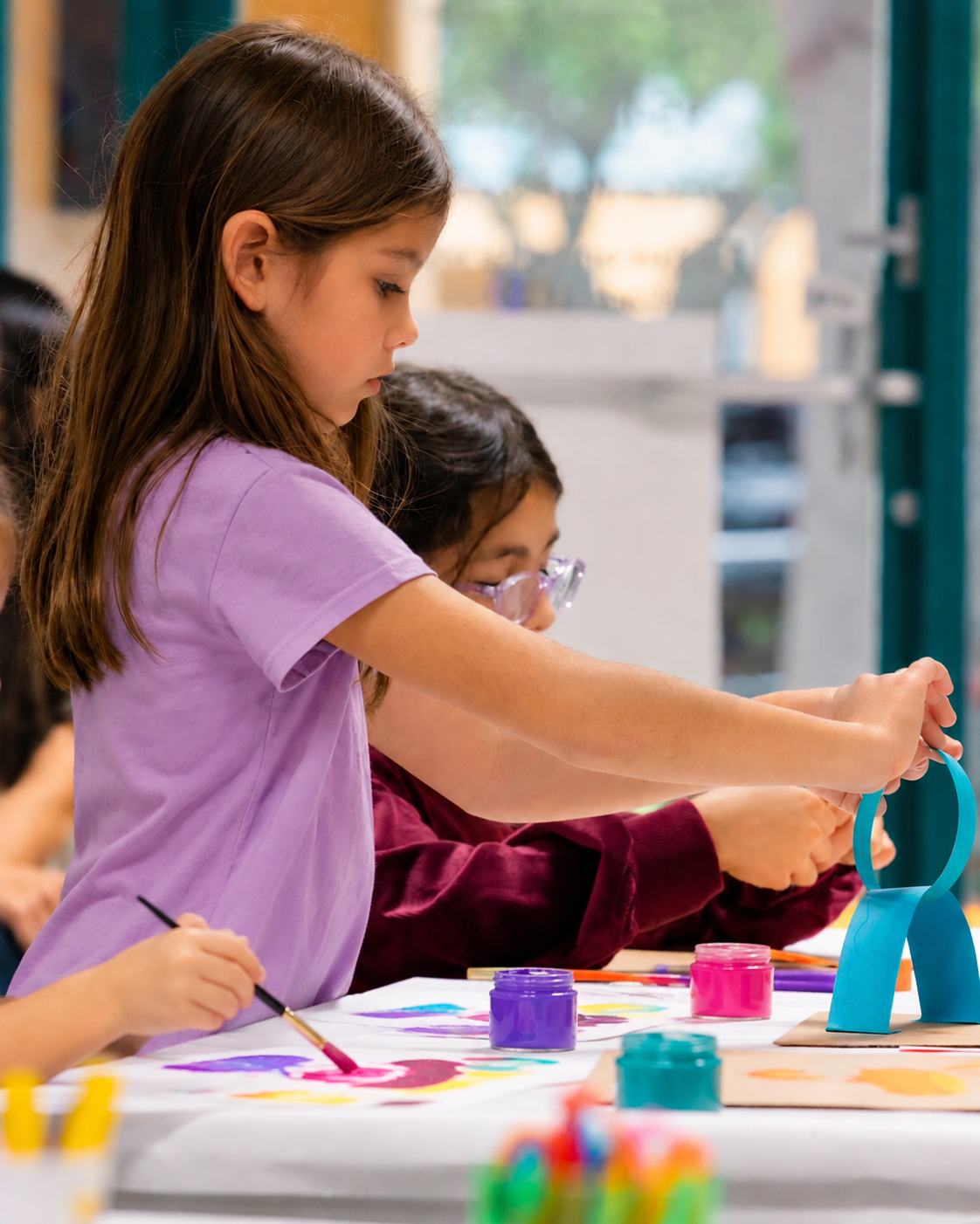Kids Painting in a Bright Art Studio.png