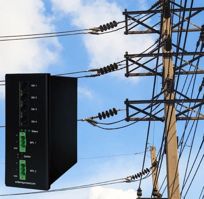 An electrical power distribution box mounted on a utility pole with power lines and insulators against a partly cloudy sky.