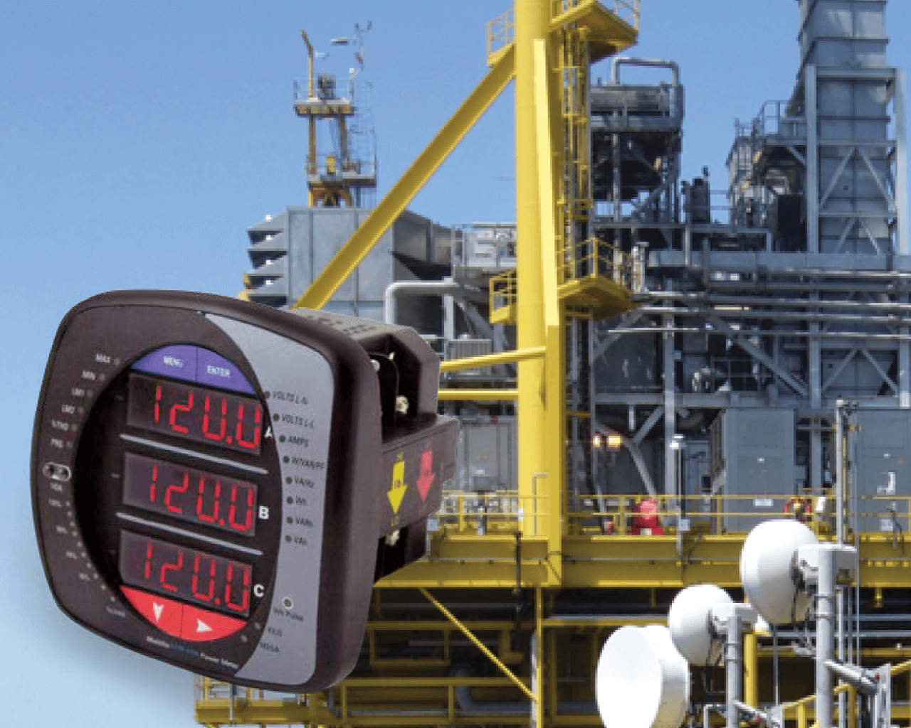 Industrial oil or gas processing plant with yellow safety railings and gray structural steel. A digital controller in the foreground displays three temperature readings, all set to 120.0 degrees.