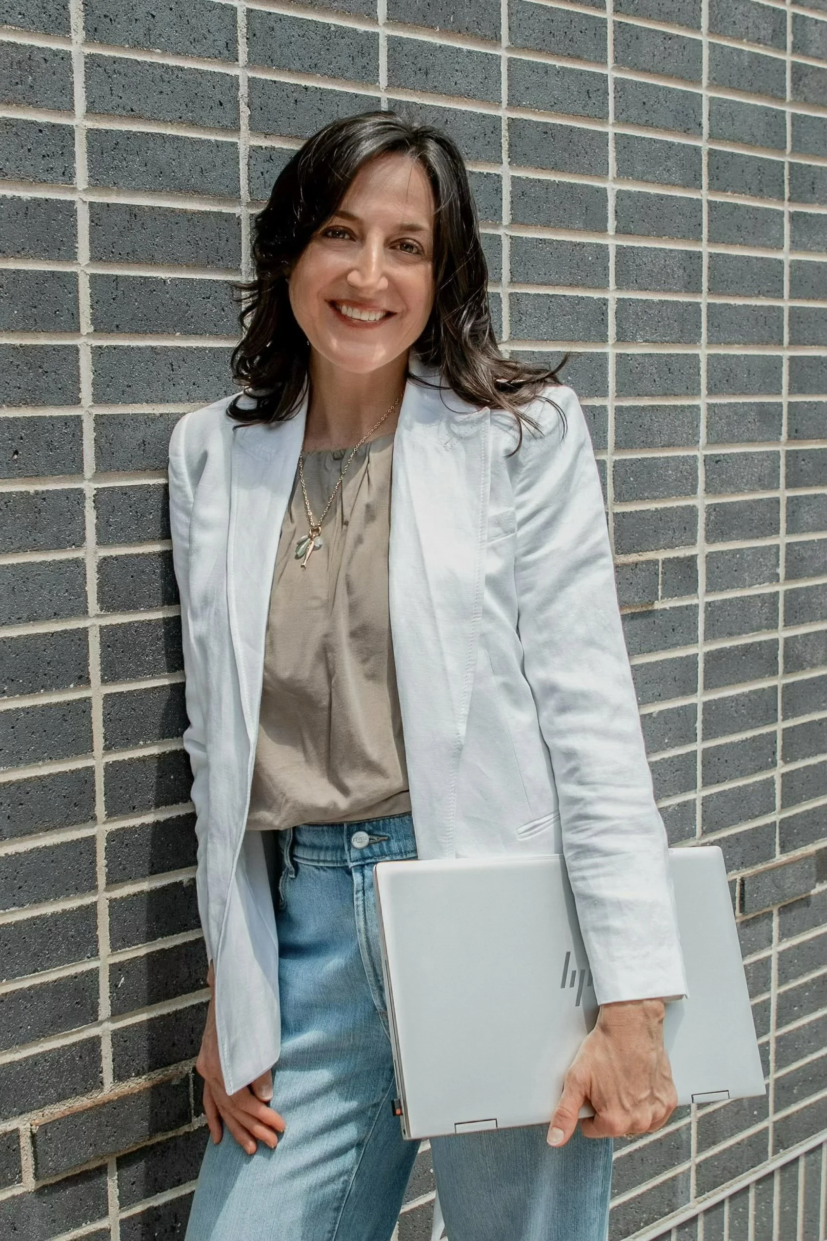 Professional portrait of Erin Peterson, commercial real estate advisor helping businesses and investors navigate commercial real estate opportunities throughout West Michigan.
