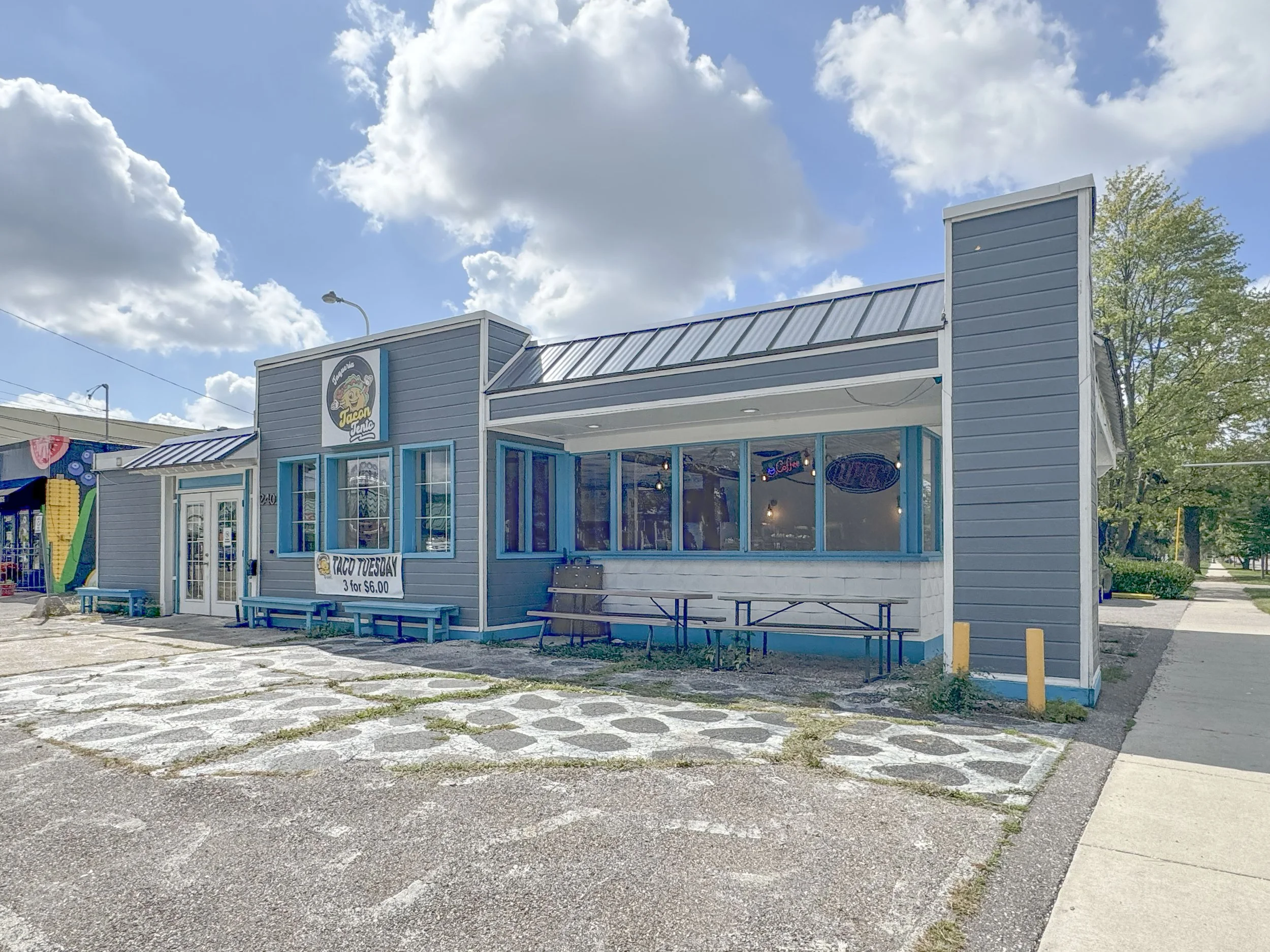 Corner exterior view of a commercial property for sale in Alger Heights, Grand Rapids, Michigan. Prime location with strong visibility and accessibility for customers and tenants.