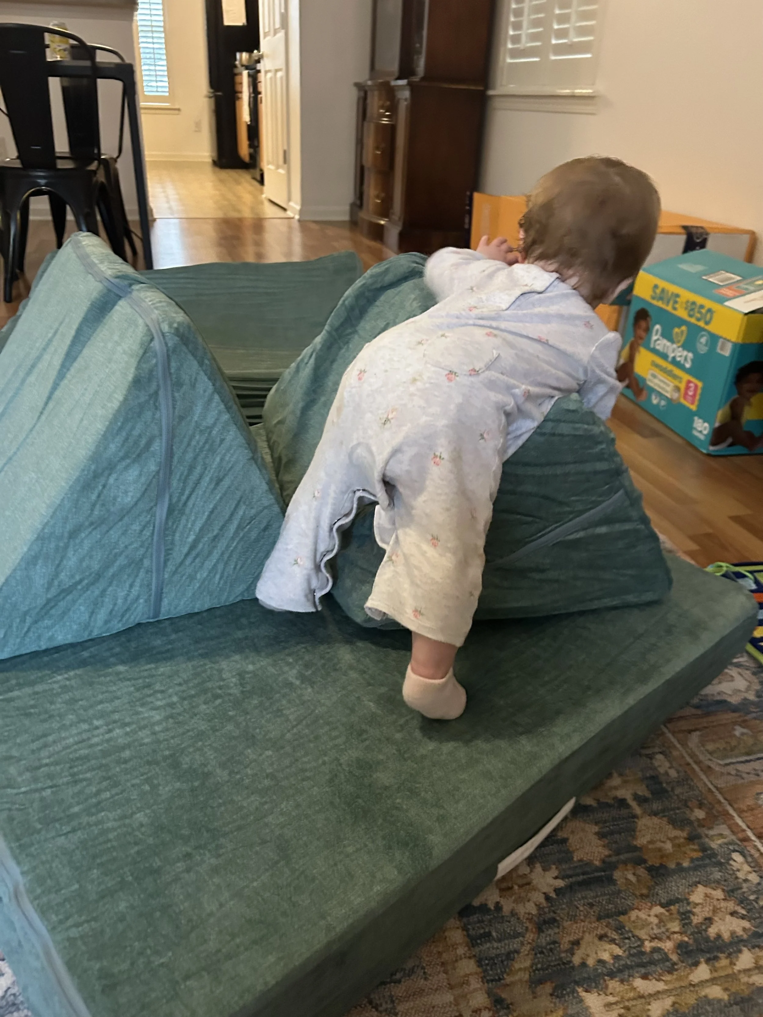 Baby playing on nugget couch