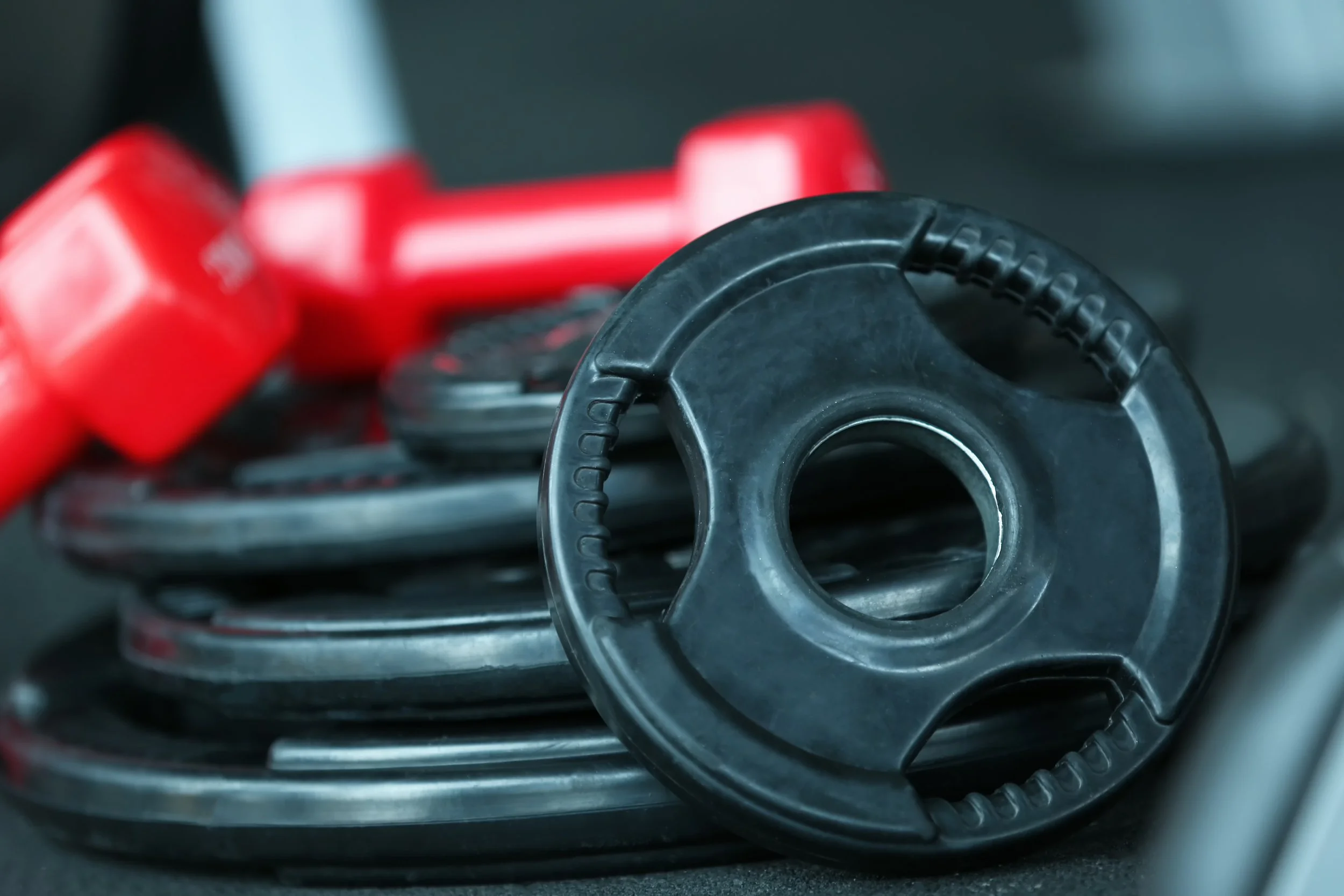 weight-plates-dumbbells-floor-gym-close-up.jpg