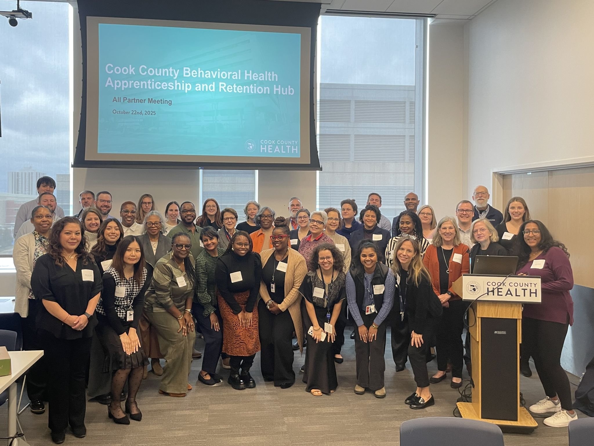Group photo of participants at a Cook County Behavioral Health Apprenticeship and Retention Hub partner meeting.