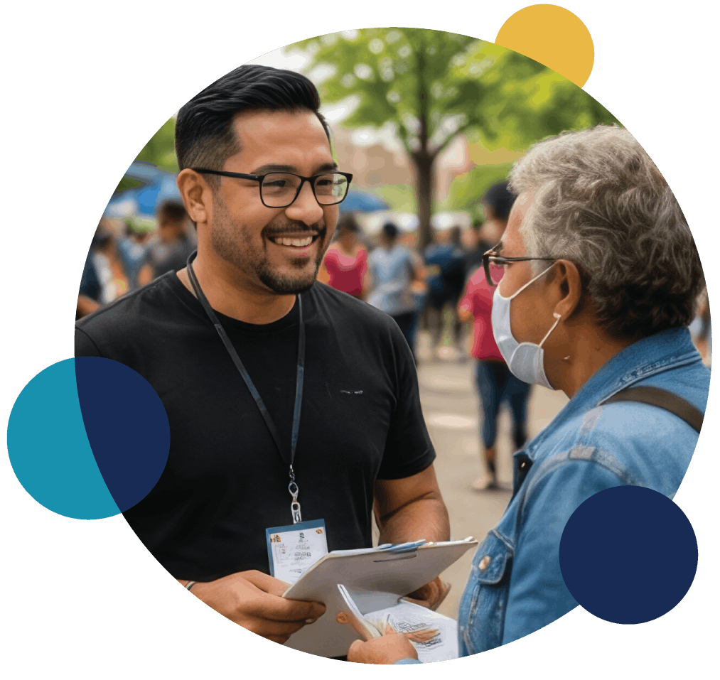 Two people talking and reviewing materials together at a community event.