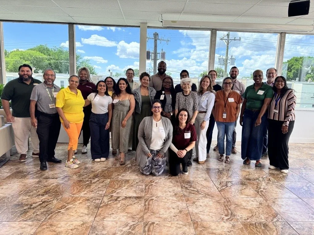 Group photo of participants gathered together at a collaborative community meeting.