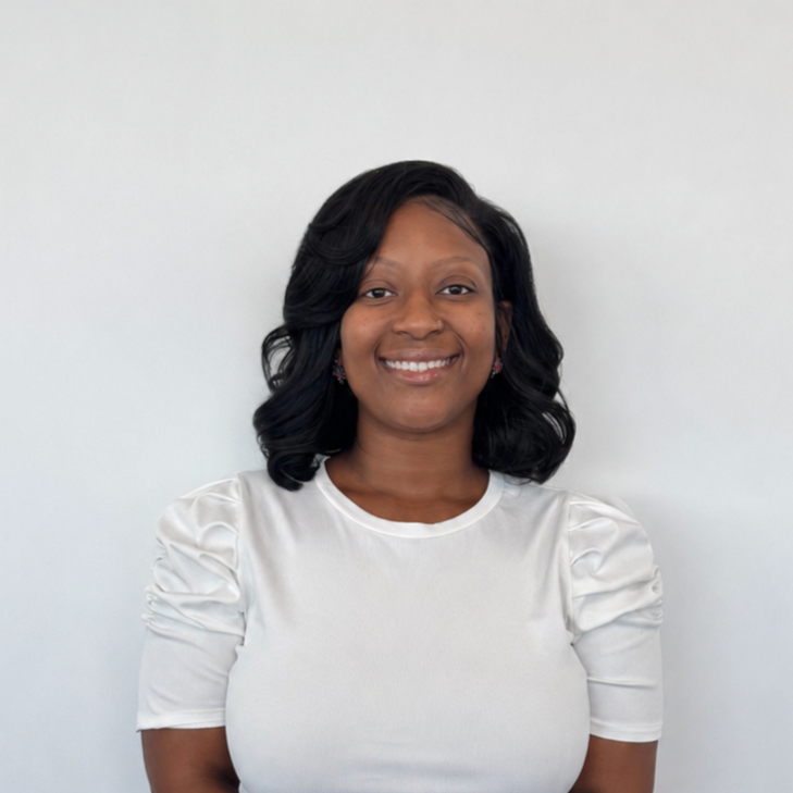 Professional headshot of a smiling woman with shoulder-length dark hair wearing a white top.
