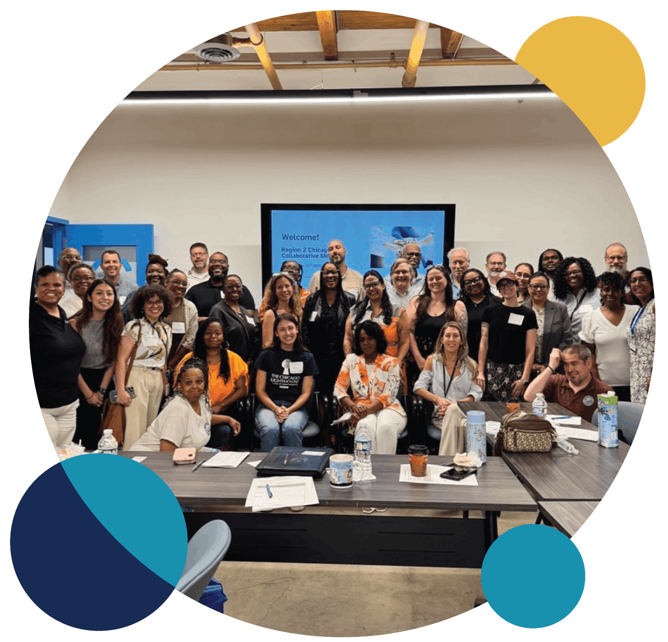 Group photo of community members gathered together at a collaborative meeting.