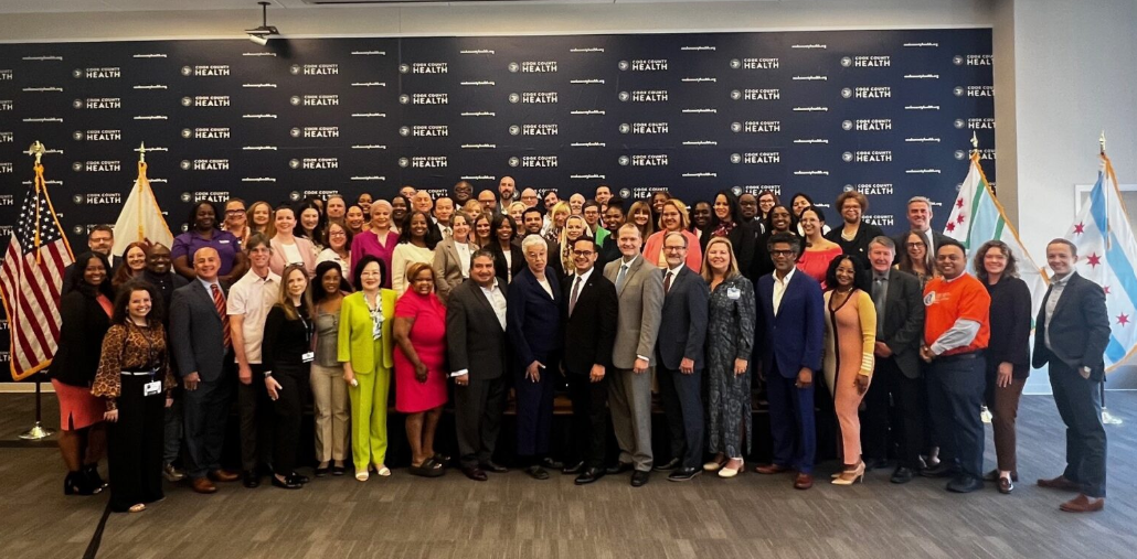 Group photo of Cook County health and community leaders gathered together at an event.