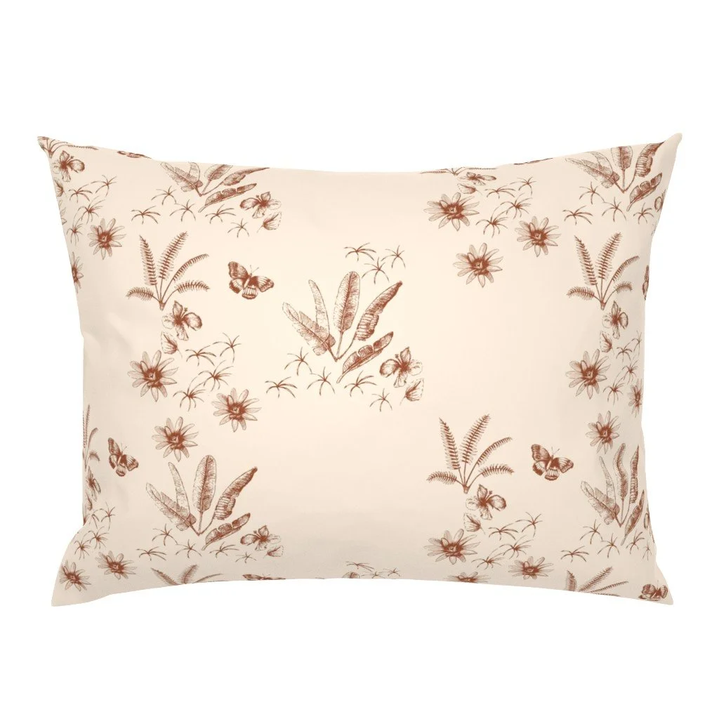 A decorative pillow with a beige background and a brown floral and butterfly pattern.