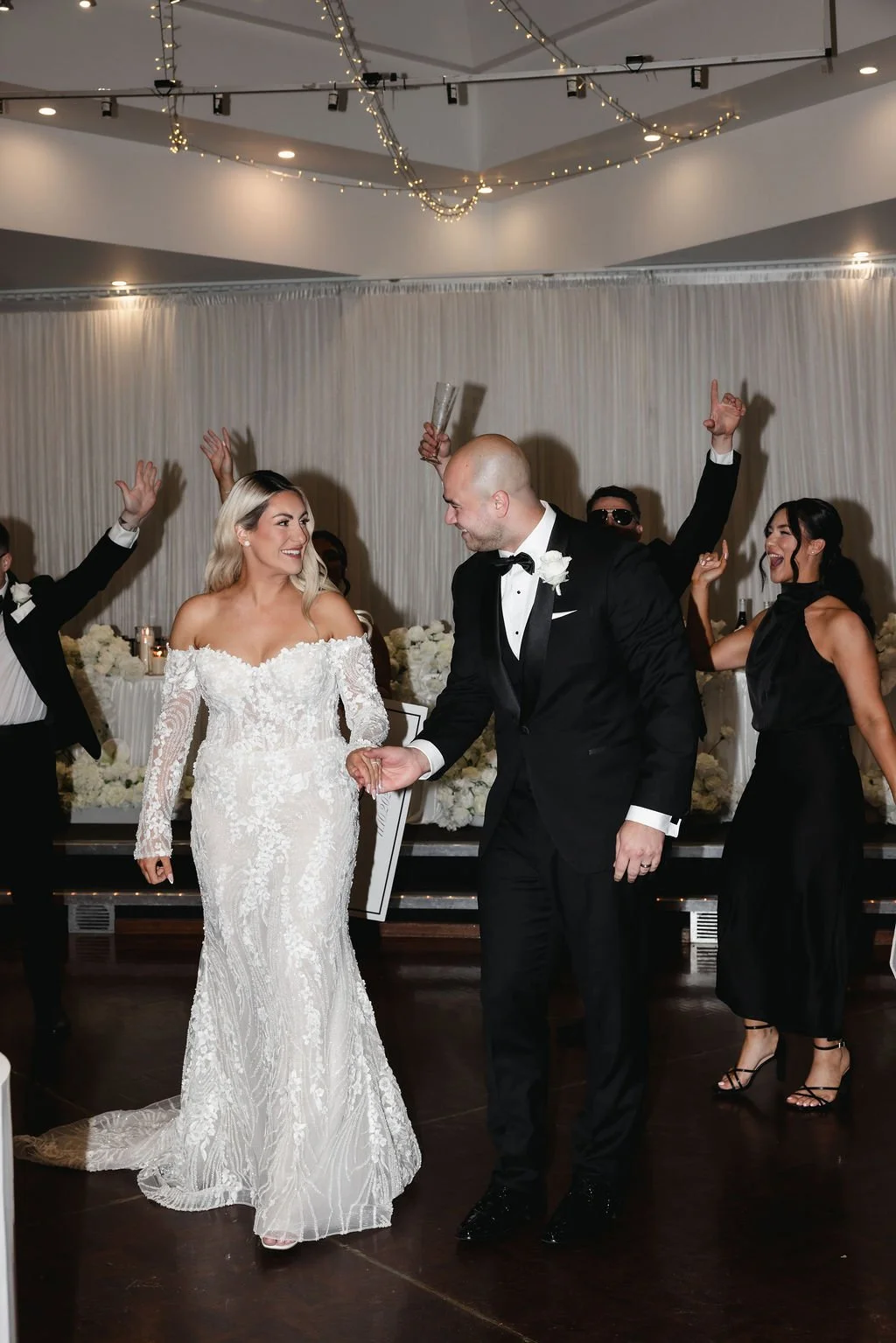 A wedding celebration showing a bride and groom dancing together, surrounded by guests celebrating at Donato reception centre in Adelaide