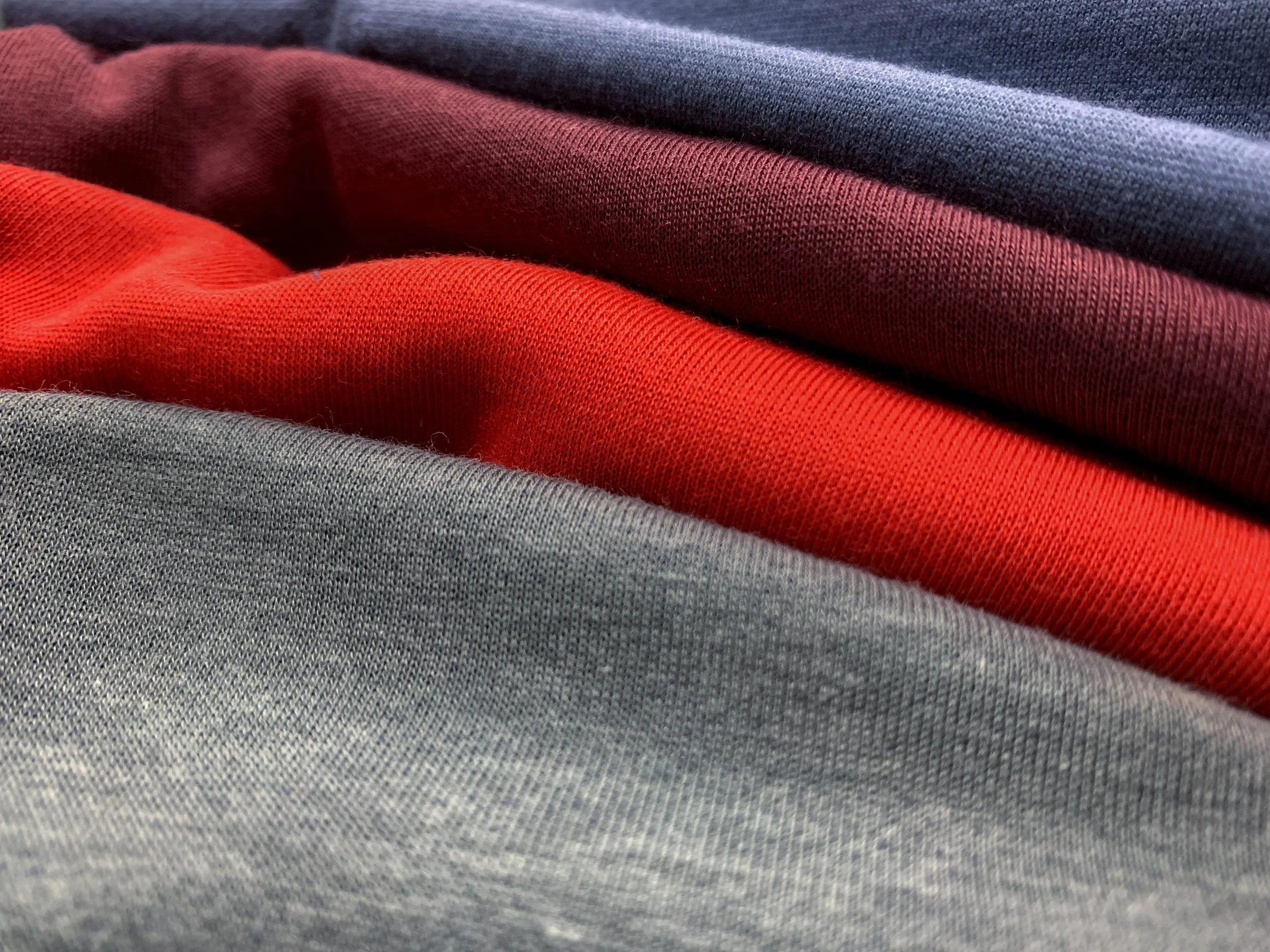 Close-up of folded fabric in grey, red, and blue colors.