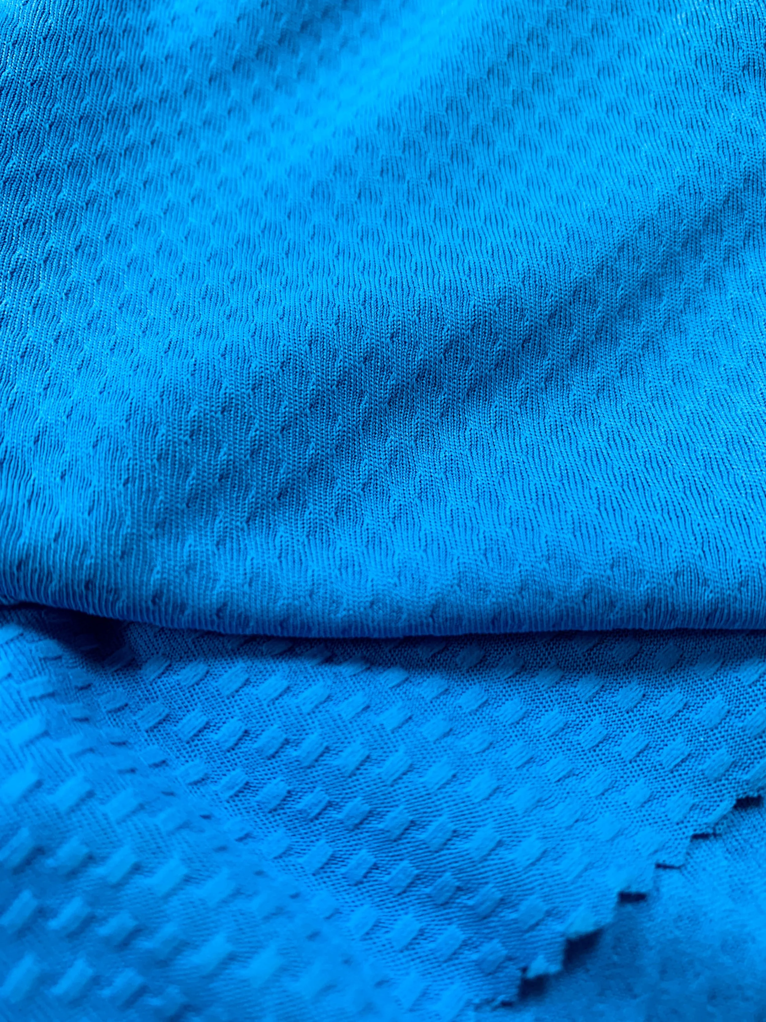 DaFon Jacquard close-up of a blue textured fabric with small loops and woven pattern.