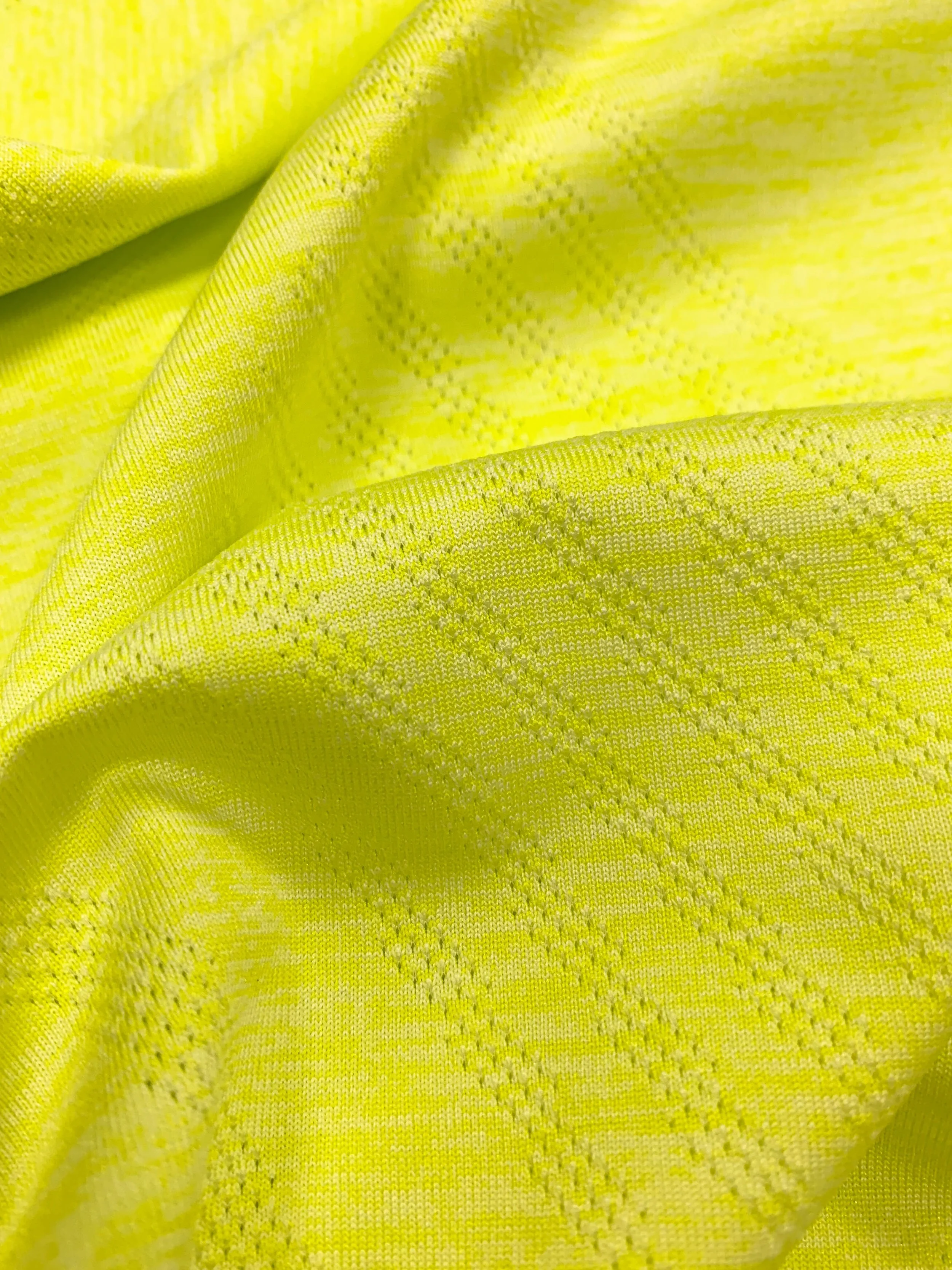 DaFon Jacquard Knit close-up of yellow textured fabric with a dotted pattern and folds.