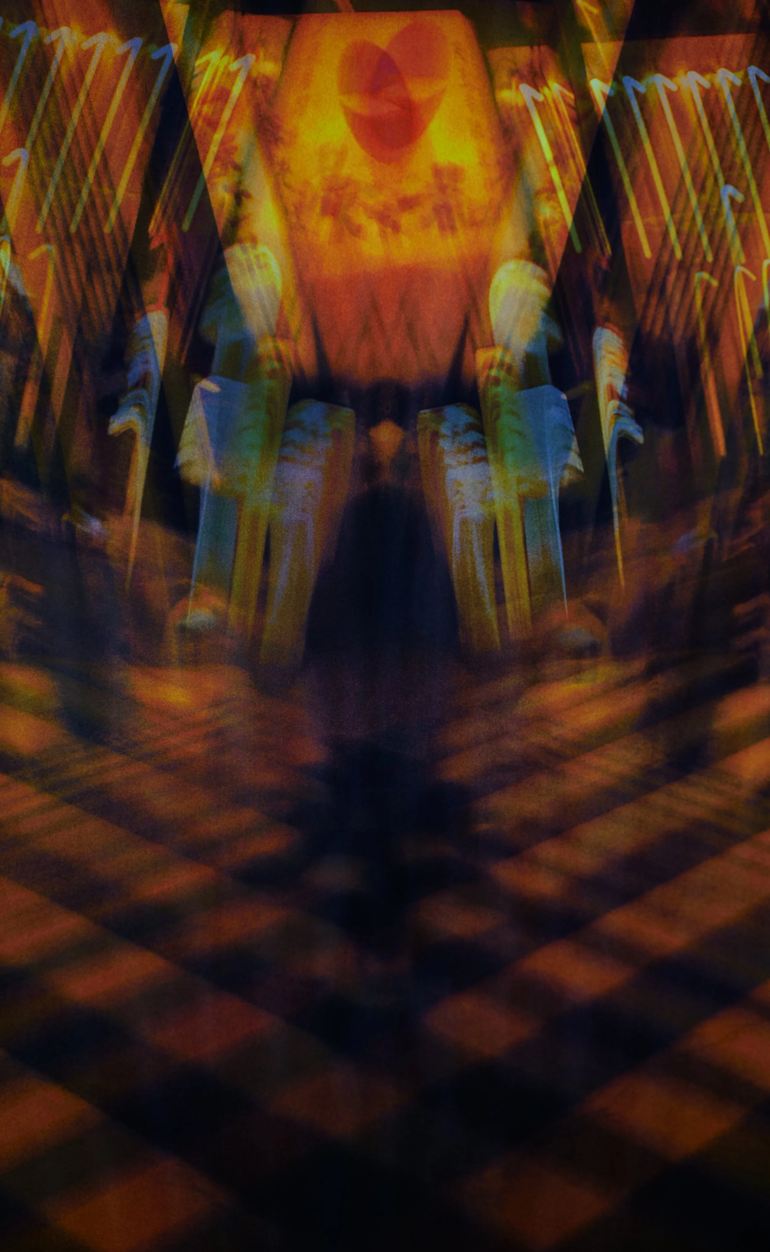 Street Fold

This image began as a road crossing and ended as a question about who is standing there. The same photograph is taken, reversed, and folded into itself until the lights and buildings rise like walls on either side and the centre drops in