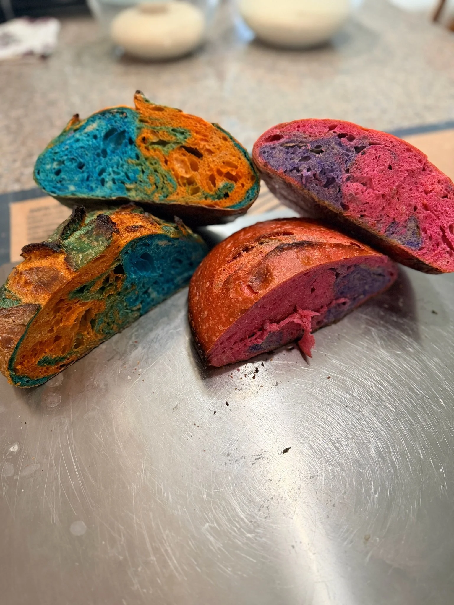 Close-up of colorful, spalted wood blocks on a metal surface with blurred background.