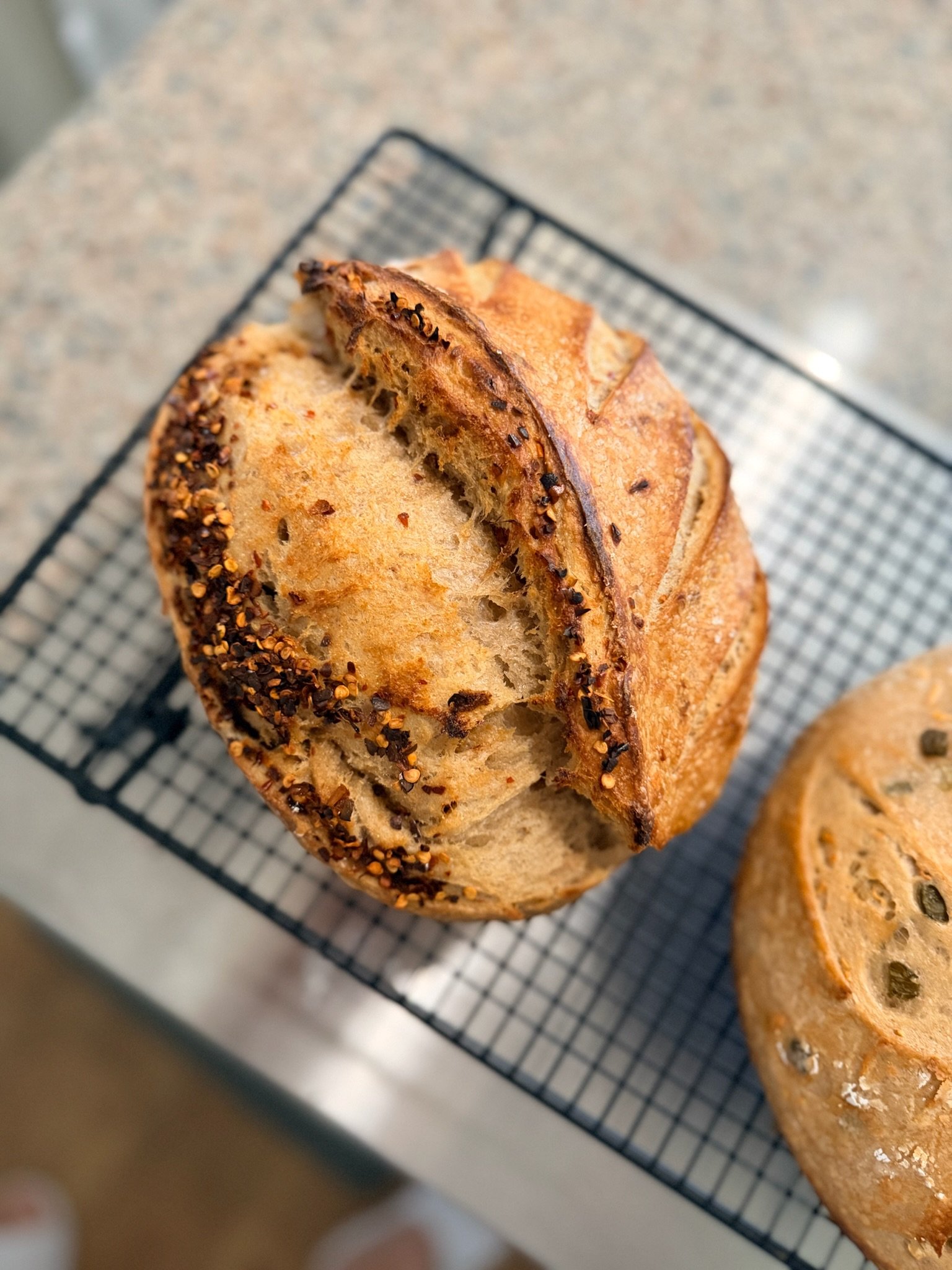 Close-up of sliced bread with a crispy crust, placed on a cooling rack.