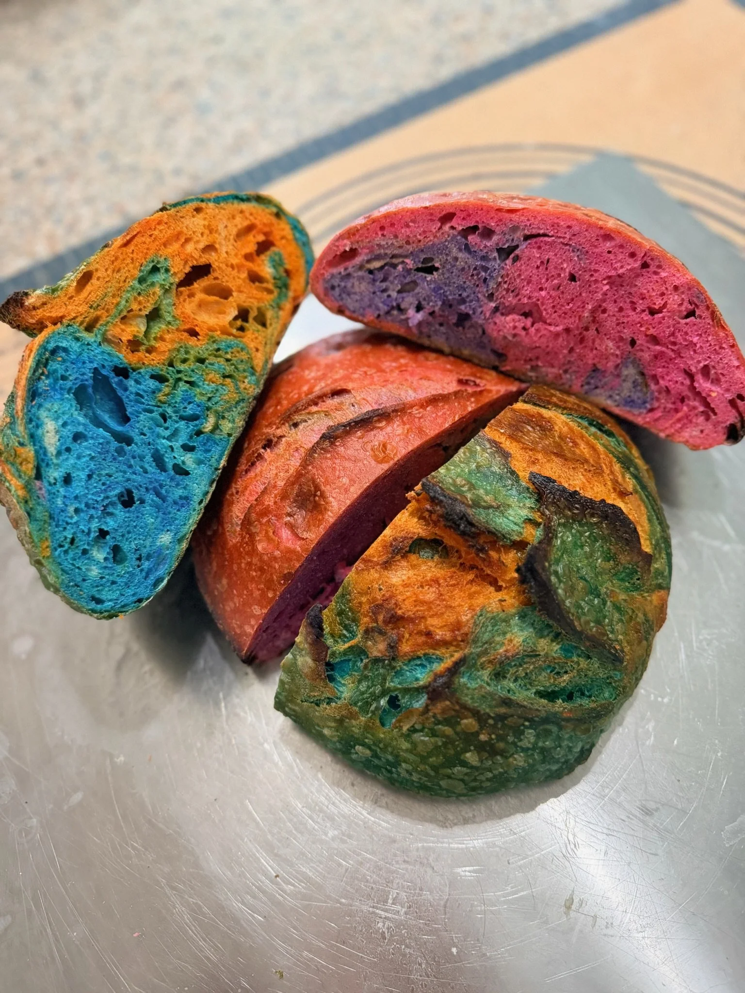 Colorful marbled bread slices on a metallic surface.