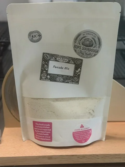 Package of pancake mix with a pink label warning about food allergy risk