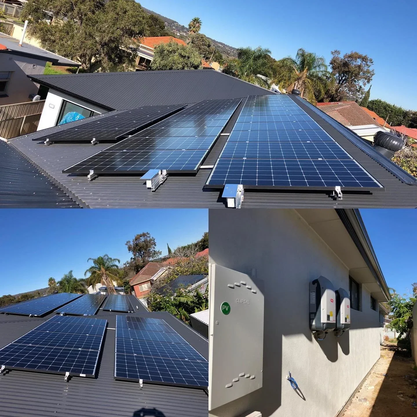 Solar panels installed on a house roof, with trees, houses, and blue sky in the background.