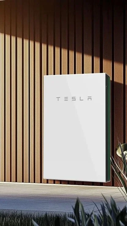Tesla power wall installed on a wooden exterior wall