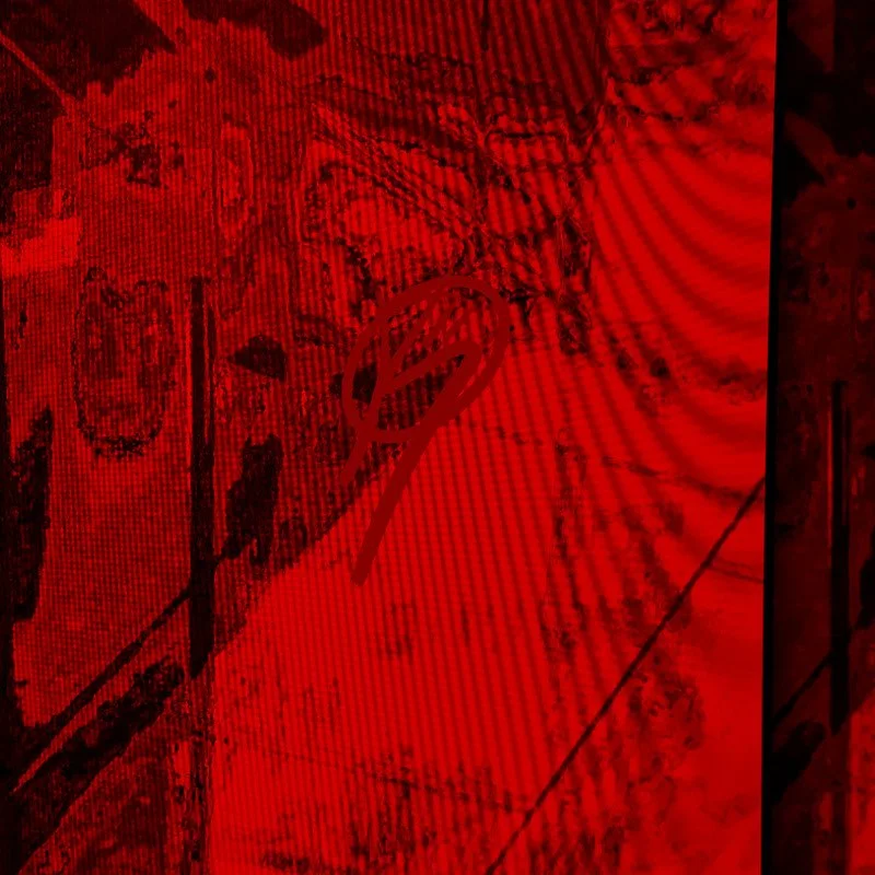 A red-tinted close-up image of a textured surface with a signature or handwritten text over it.