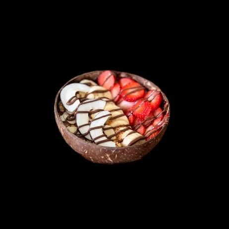 A pizza with pepperoni, tomatoes, black olives, mushrooms, and cheese on a round wooden pizza board.