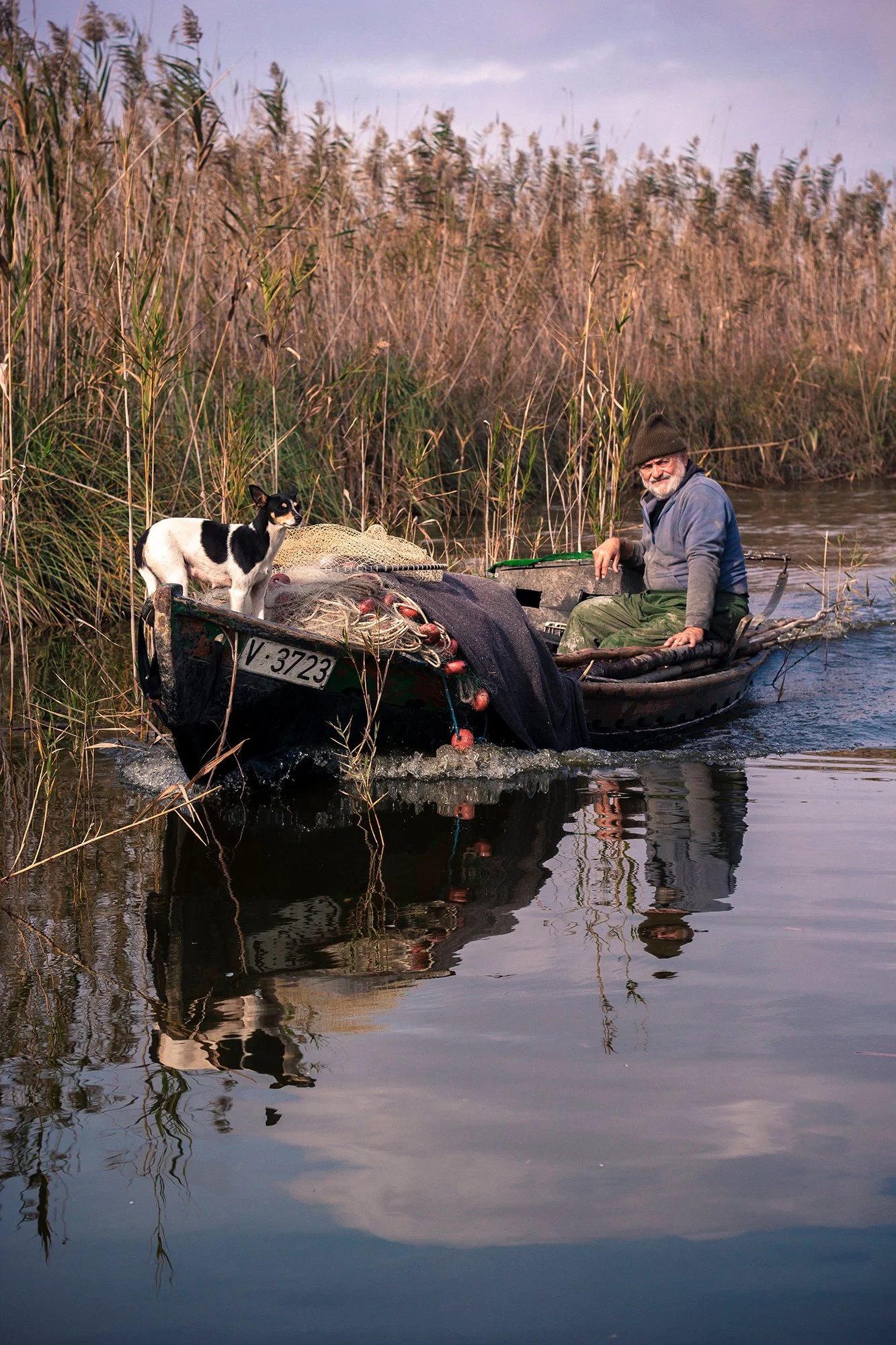 Traditional fisherman navigating the waters of Albufera, Spain, photographed during a documentary travel journal.