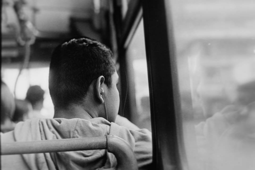 Child looking through the window of public transportation