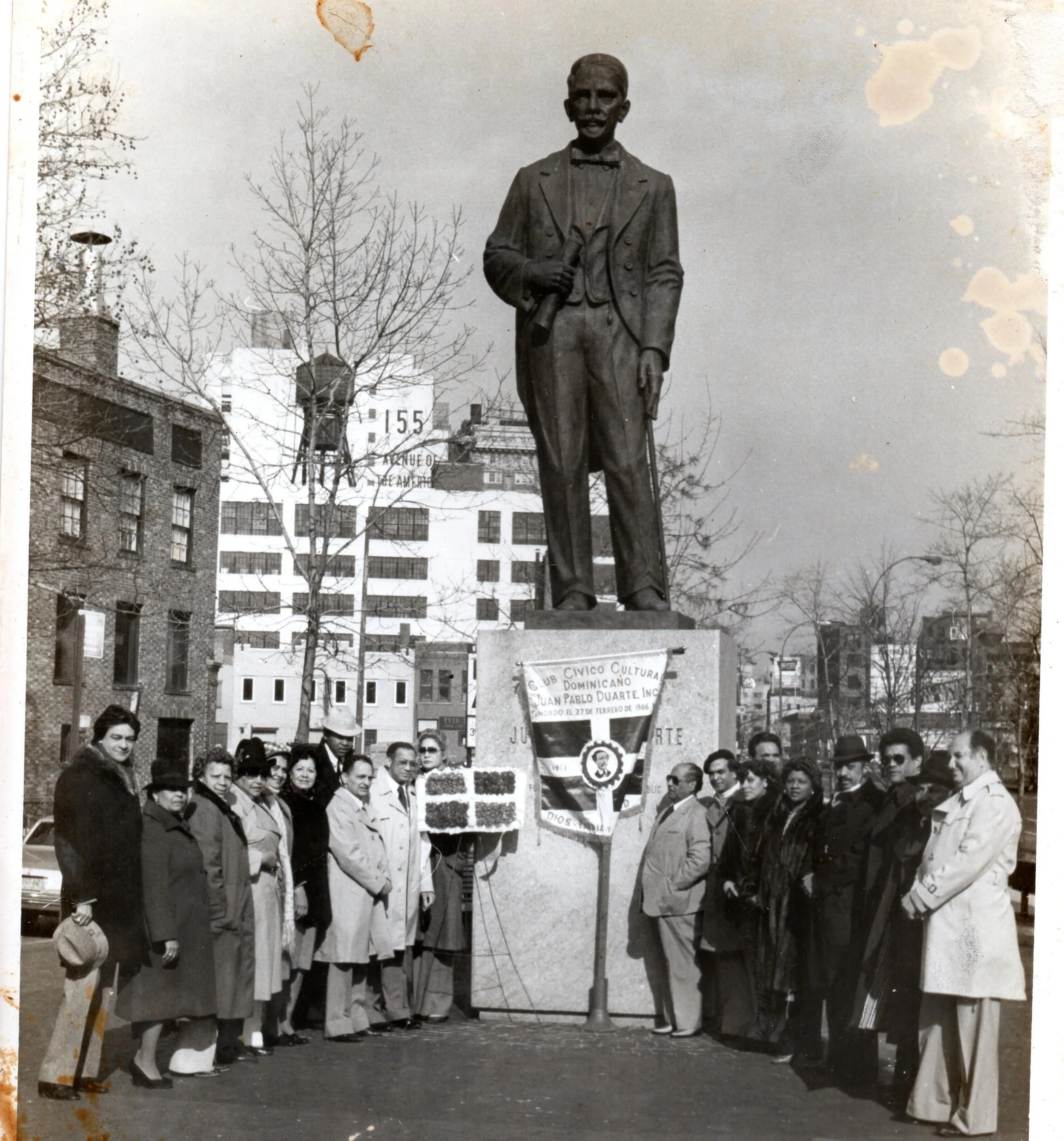 Community gathering around a monument to Juan Pablo Duarte in a historical photograph from My Grandfather Is Not In This Story.