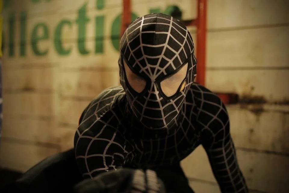 Close-up portrait of a masked performer during a community festival