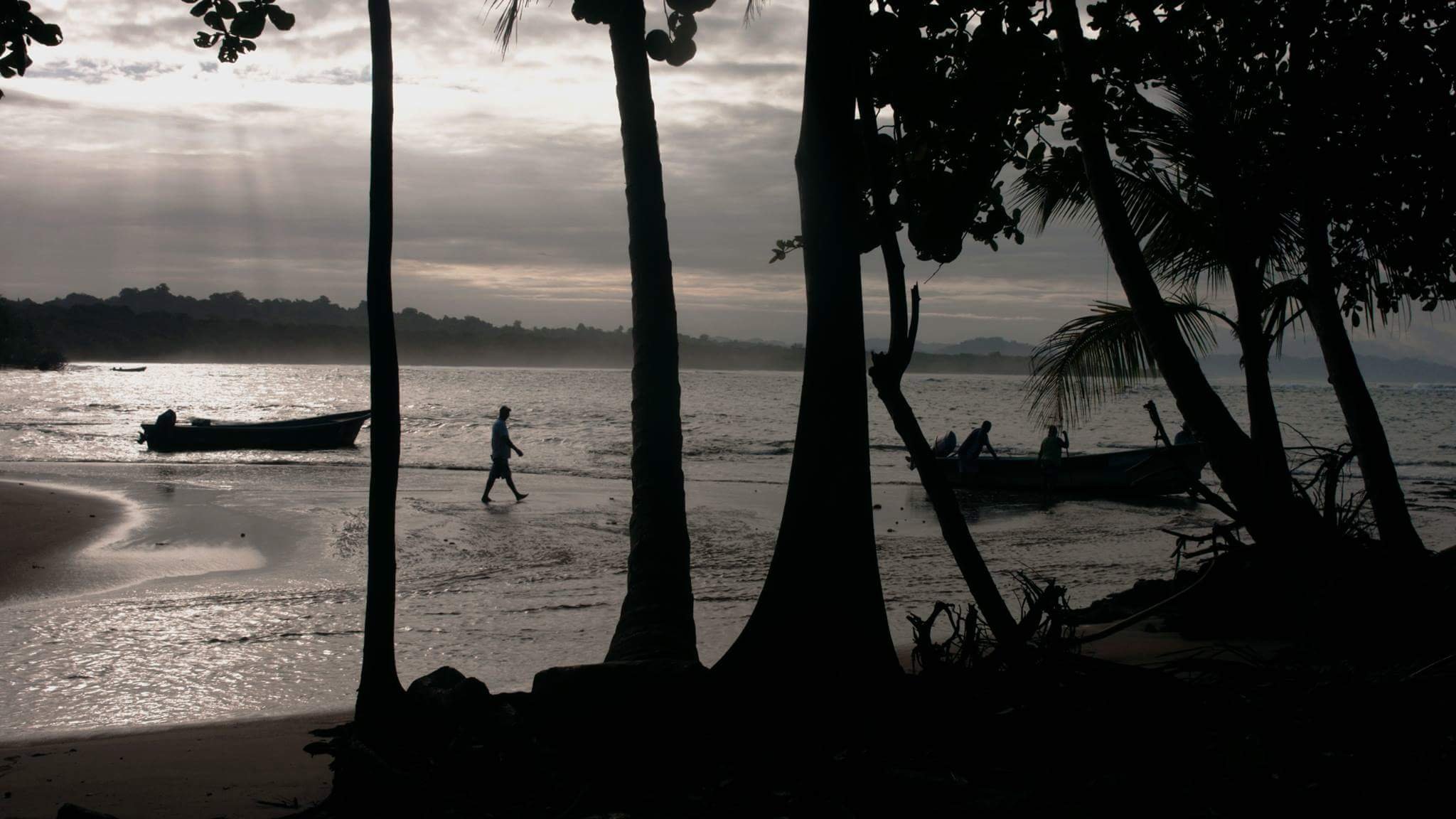 Fishing boats resting along the shoreline of Costa Rica in Between Two Shores.