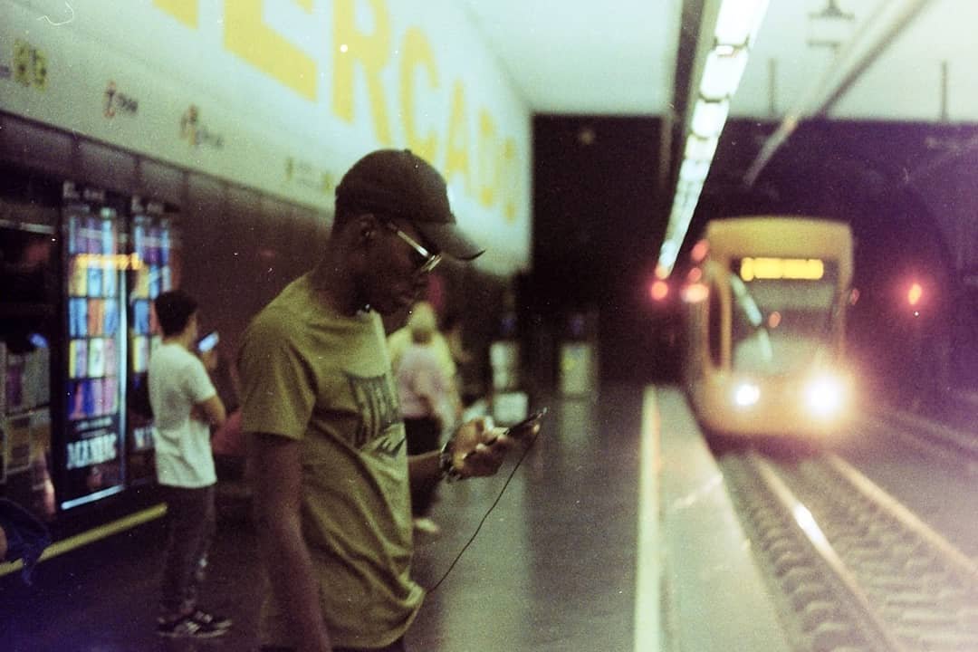 Commuter waiting alone on a train platform at dusk