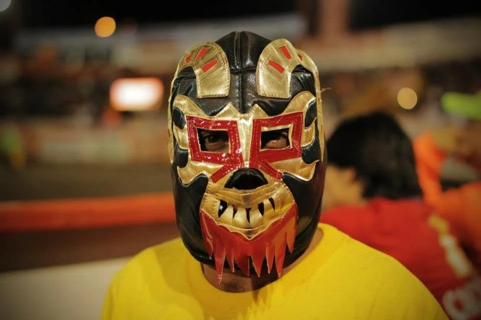 Portrait of a performer wearing a traditional festival mask