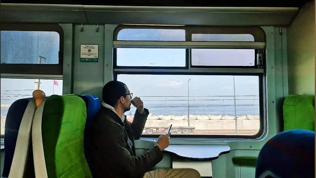 Passenger looking through a train window during a journey