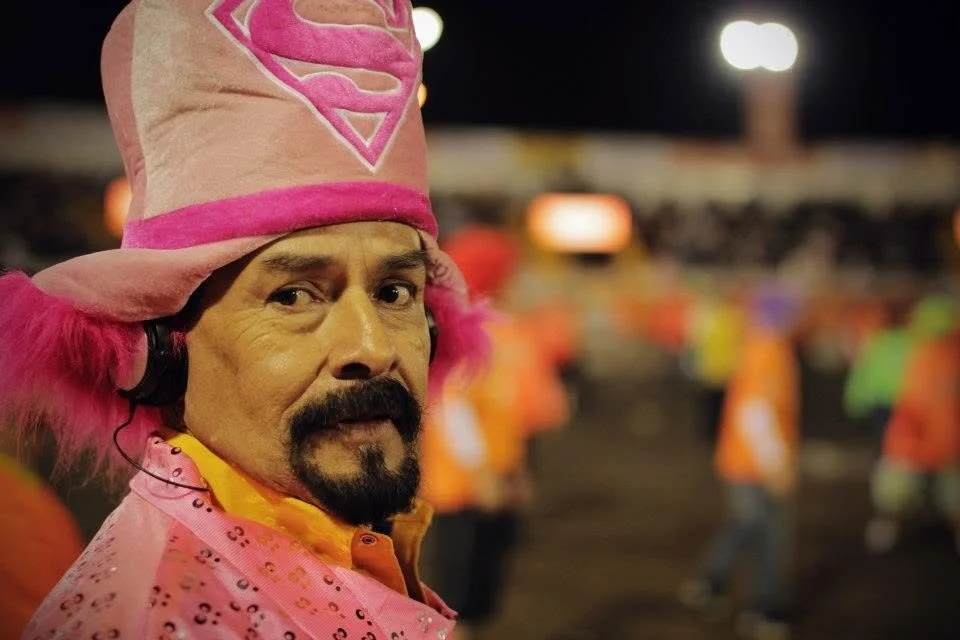 Festival character wearing a bright pink costume and hat