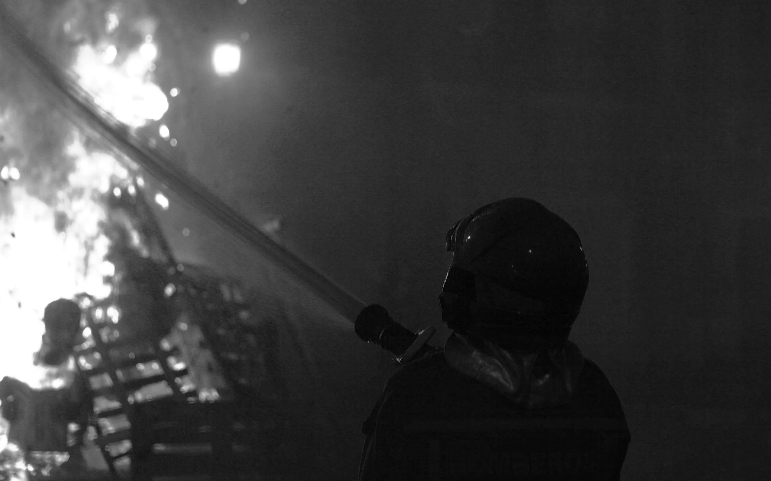 Firefighter working through smoke during Las Hogueras celebrations in Alicante.