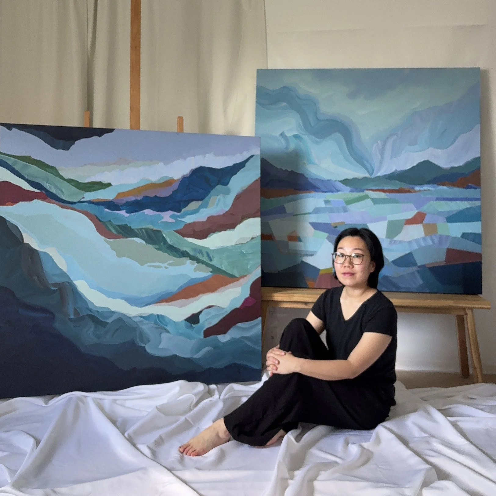 Abstract artist Eunmee Kim in her studio with large paintings
