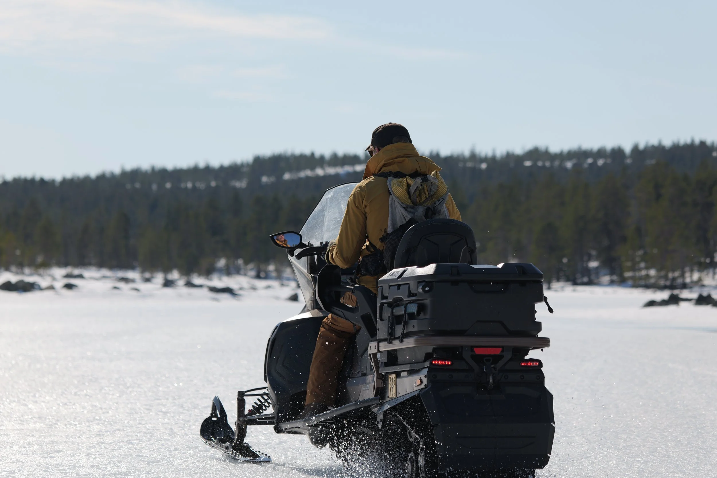 Snowmobile safari through snowy forests in Oulu, Finland