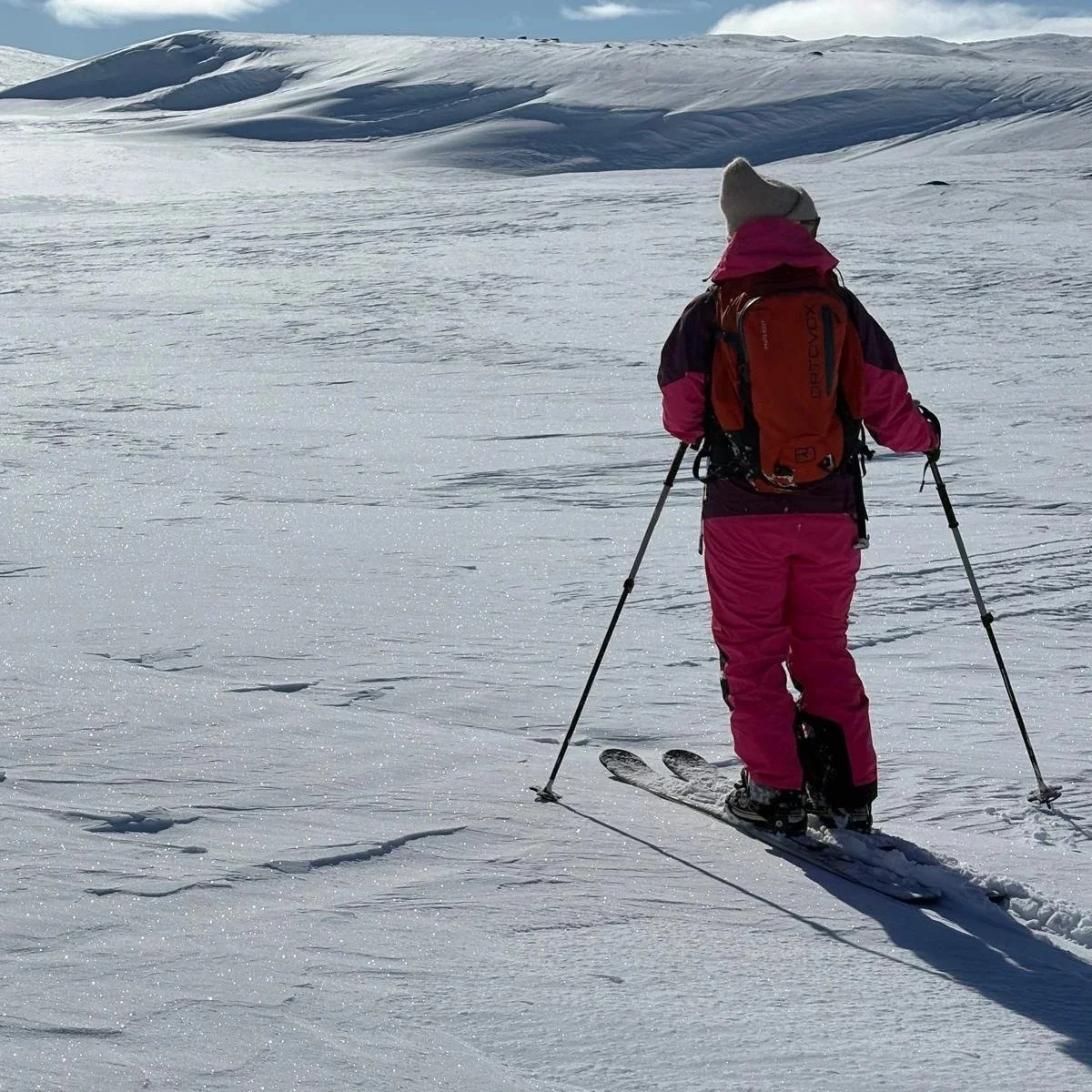 Traveller using sliding snowshoes in an open winter landscape in Finland
