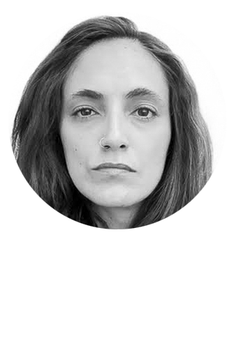 Black and white portrait of a woman with straight hair, nose piercing, and serious expression.