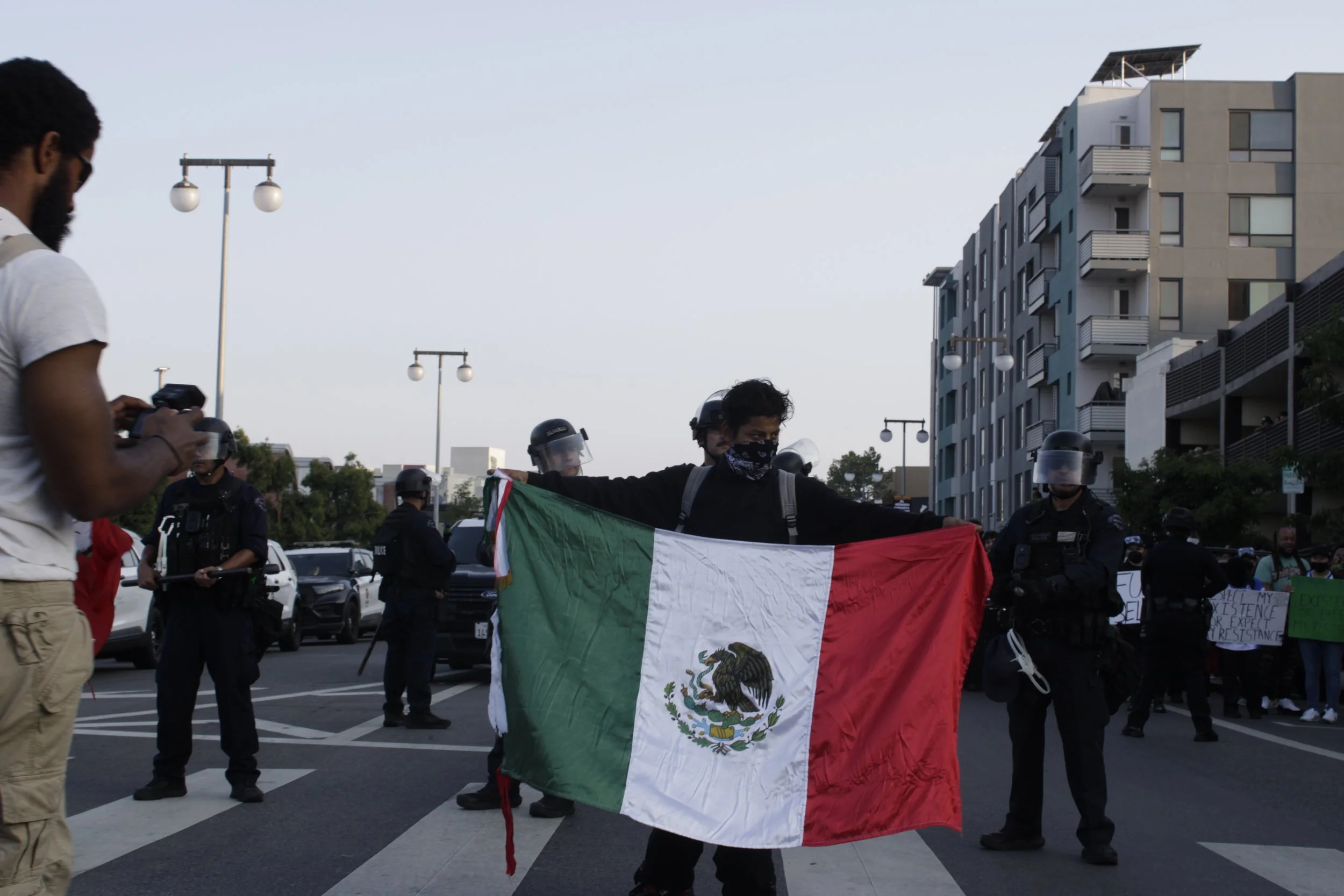 Boy displays Mexican flag in front of LAPD