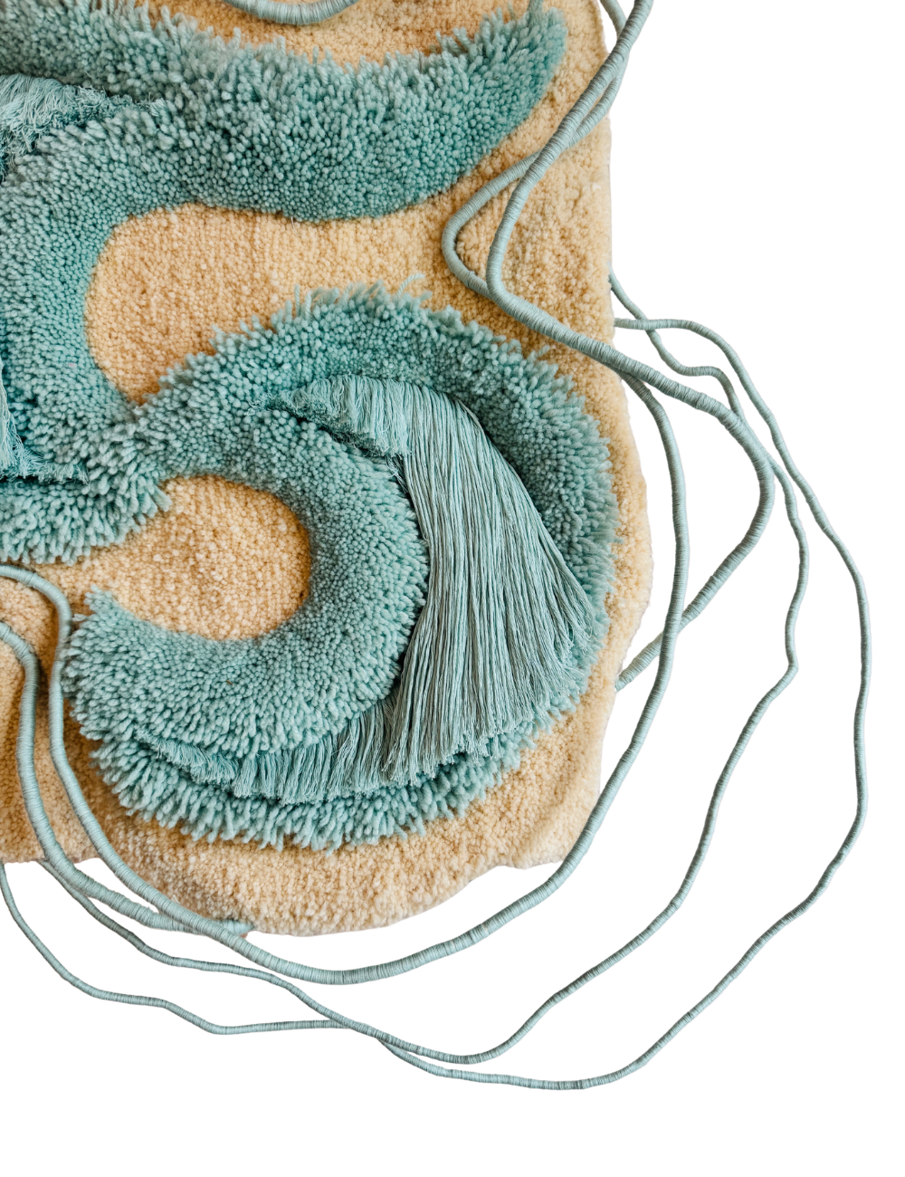 Close-up of an abstract textured rug with blue and beige fibers, alongside a wireframe structure.