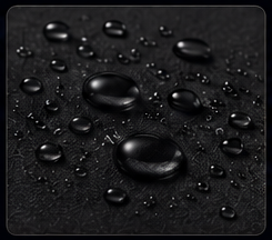 Close-up of water droplets on a dark, wet surface.
