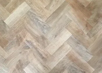 Wooden herringbone patterned floor.