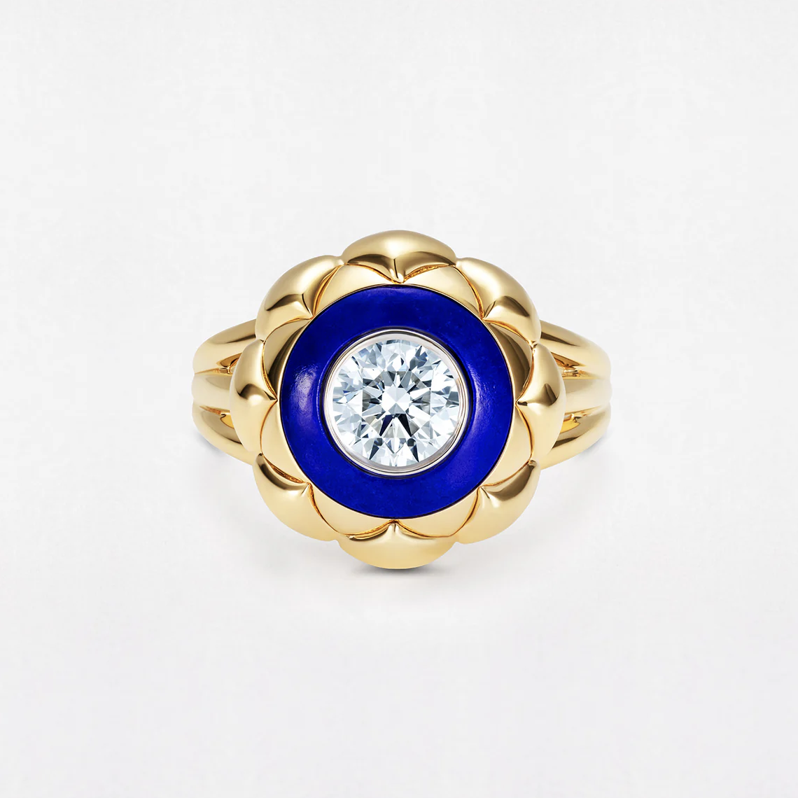 A gold ring featuring a central diamond surrounded by a blue enamel circle.