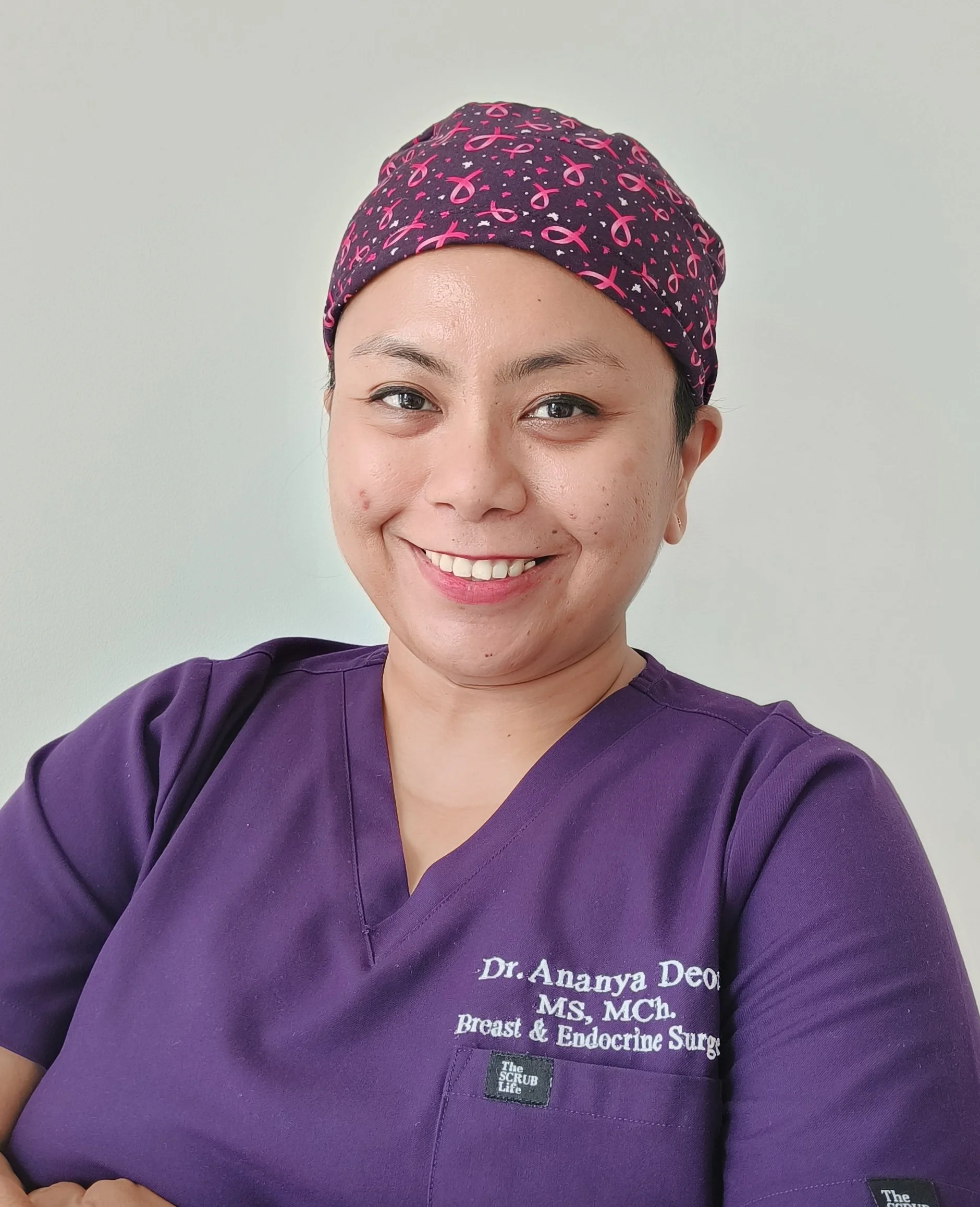 Close-up photo of Dr. Ananya Deori, a breast and endocrine surgeon, who is in her OT scrubs that indicate she is a Breast Oncosurgeon